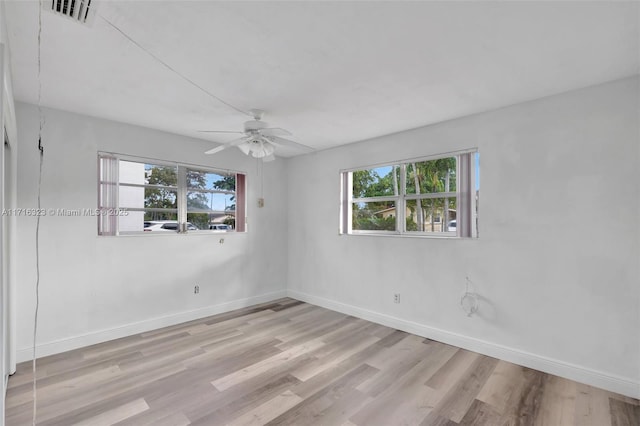 unfurnished room featuring a wealth of natural light, light wood-type flooring, and ceiling fan