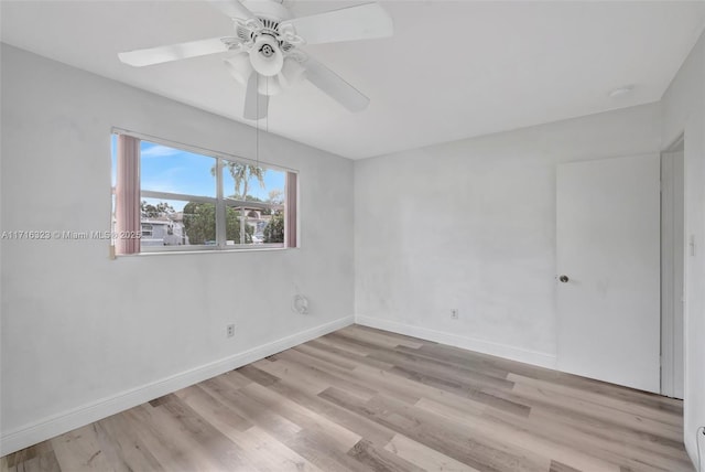 empty room with ceiling fan and light hardwood / wood-style floors