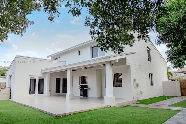 back of house with a yard, a patio area, and french doors