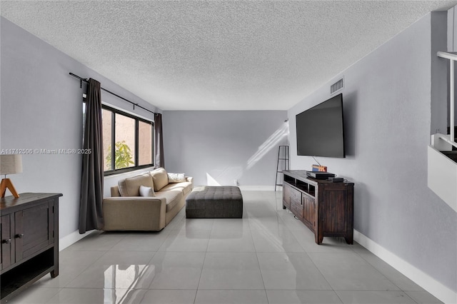 living room featuring light tile patterned floors and a textured ceiling