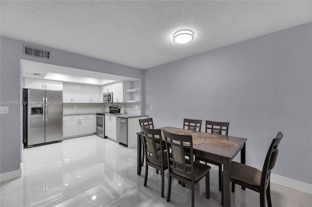 dining space with a textured ceiling