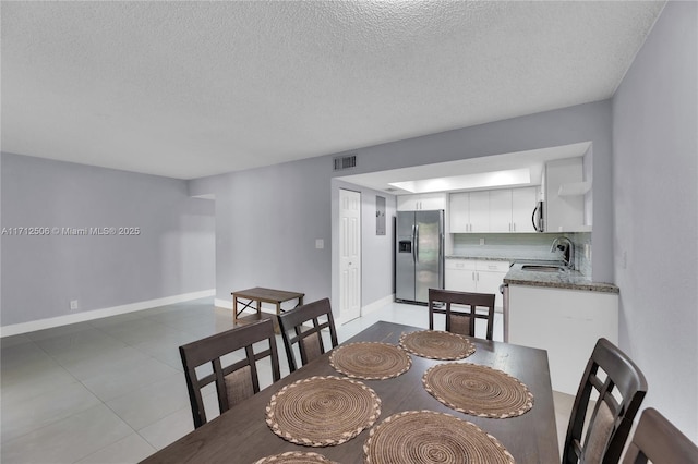 dining room with sink and a textured ceiling