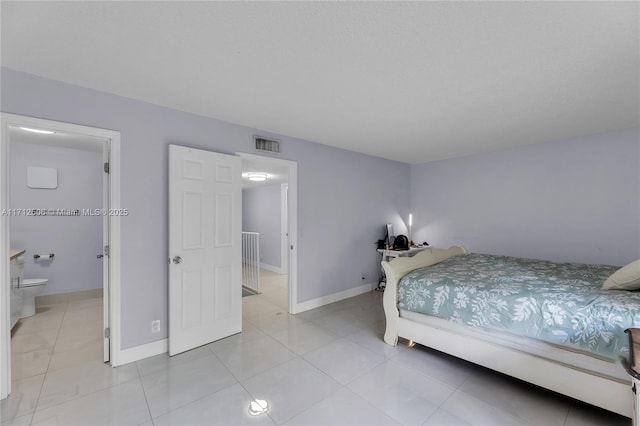 tiled bedroom featuring connected bathroom