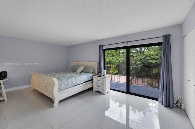 bedroom with light tile patterned floors, a textured ceiling, access to outside, and a closet