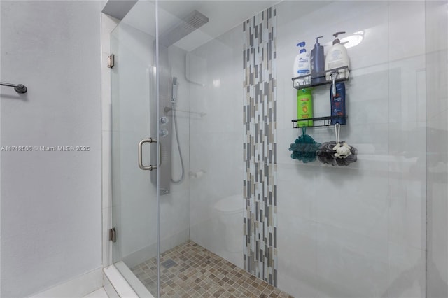 bathroom with a shower with shower door