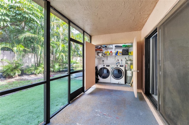 laundry area with separate washer and dryer, a textured ceiling, and water heater