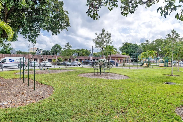 surrounding community with a yard and a playground