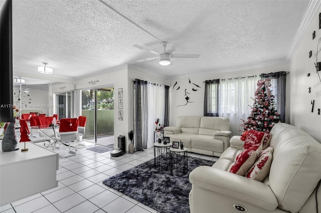 living room with light tile patterned floors, ornamental molding, ceiling fan, and a healthy amount of sunlight