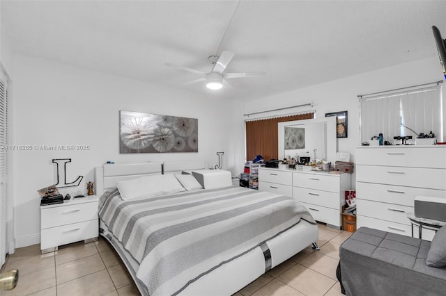 bedroom with ceiling fan and light tile patterned flooring