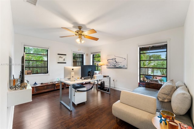 home office featuring ceiling fan, dark wood-type flooring, and a healthy amount of sunlight