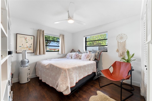 bedroom with dark wood-type flooring and ceiling fan