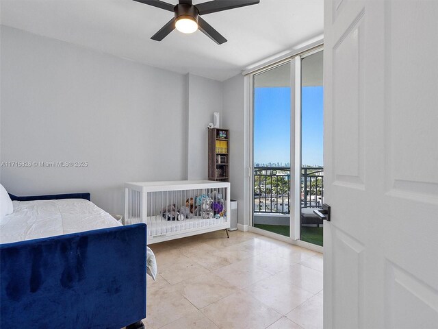 bedroom with light tile patterned floors, access to outside, expansive windows, and ceiling fan