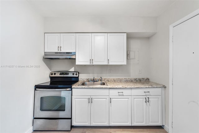 kitchen with stainless steel electric stove, white cabinetry, and sink