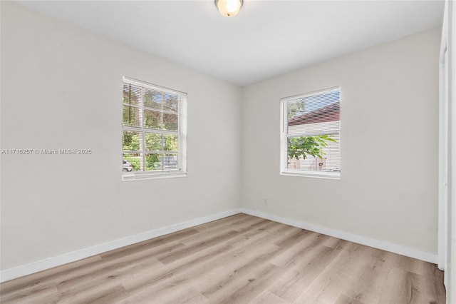 empty room with a healthy amount of sunlight and light wood-type flooring