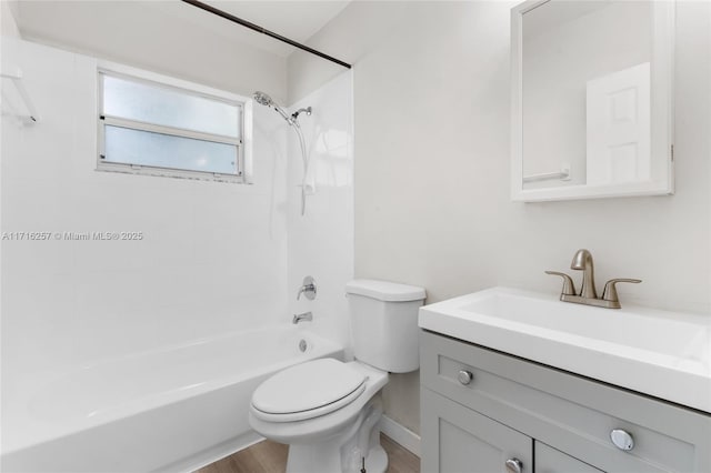 full bathroom with tiled shower / bath, hardwood / wood-style floors, vanity, and toilet