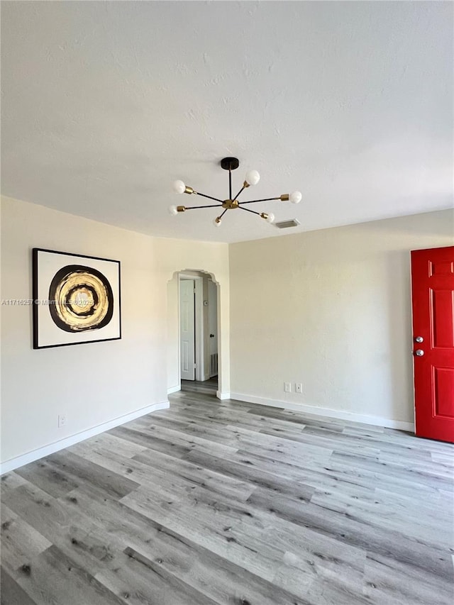 interior space featuring light hardwood / wood-style floors and an inviting chandelier