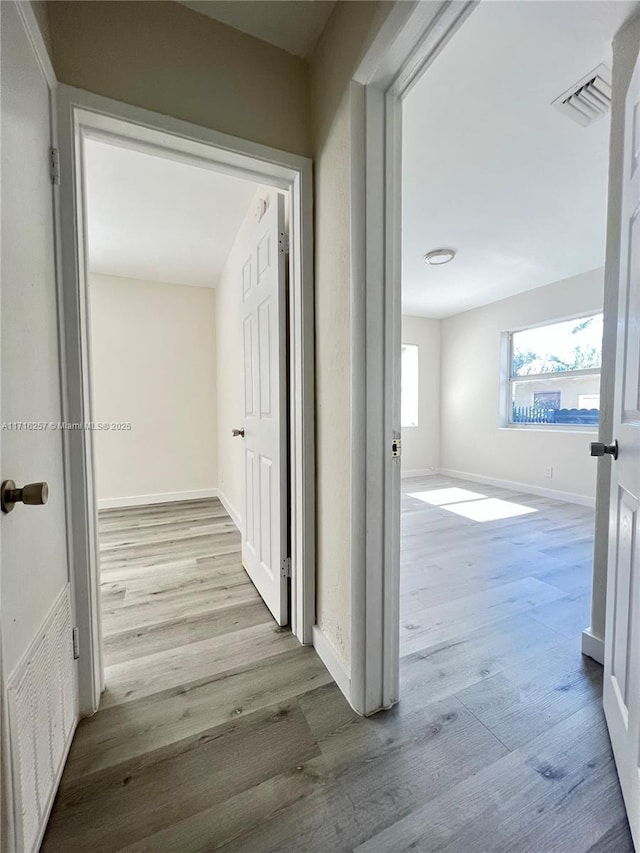 hall with light wood-type flooring