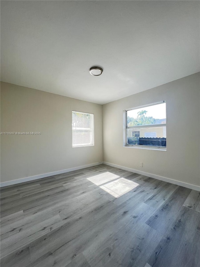 unfurnished room with hardwood / wood-style floors