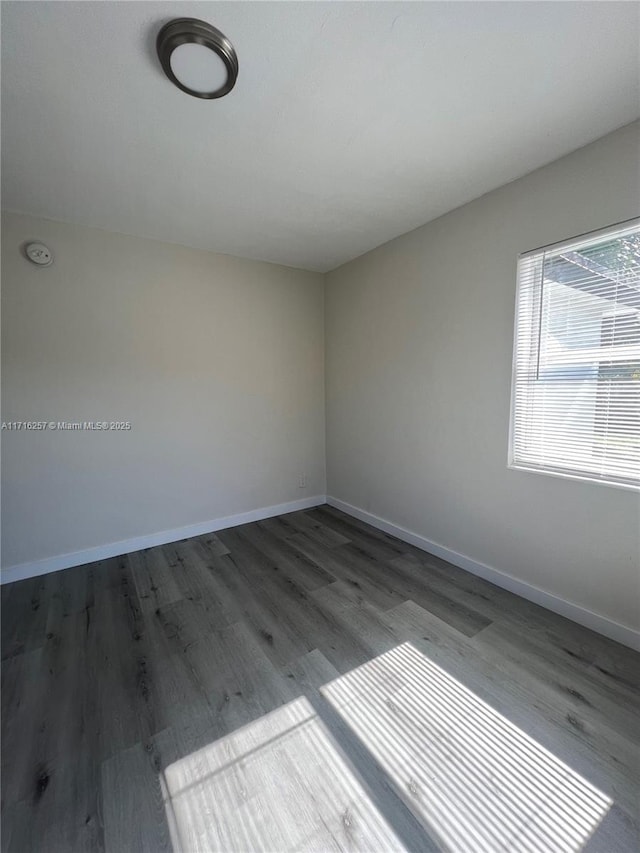 unfurnished room with wood-type flooring