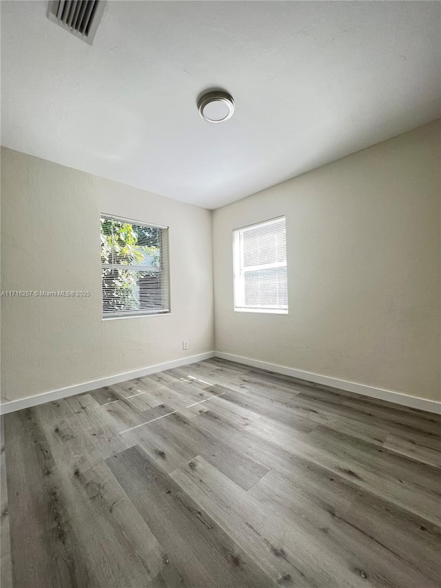 unfurnished room featuring hardwood / wood-style floors