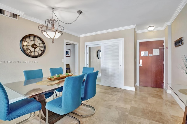 dining room with crown molding and a chandelier