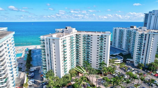 bird's eye view with a water view and a beach view