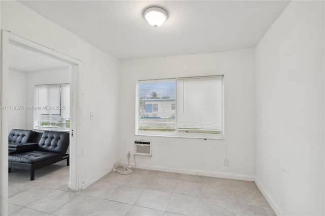 tiled spare room featuring a wall mounted AC