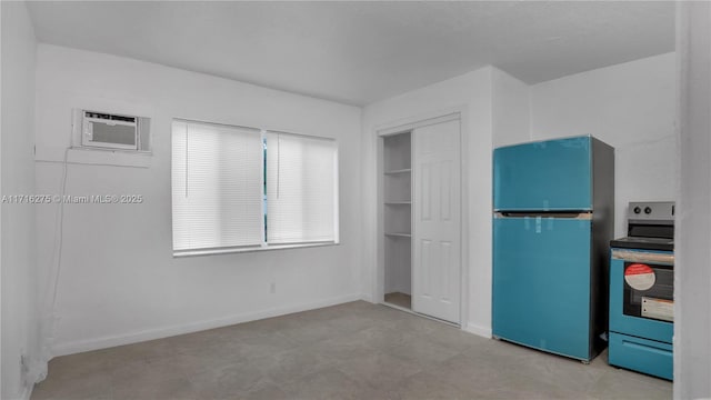 unfurnished bedroom featuring a wall unit AC, stainless steel refrigerator, and a closet