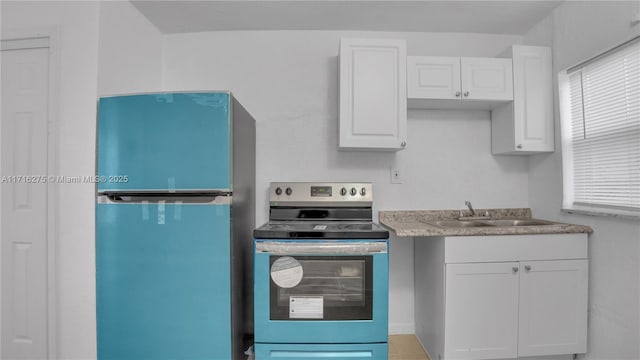 kitchen with white cabinetry, sink, and stainless steel appliances