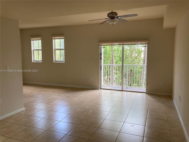 spare room featuring light tile patterned floors and ceiling fan