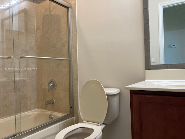 full bathroom with vanity, enclosed tub / shower combo, and toilet