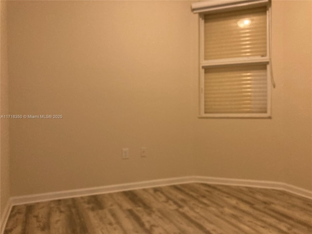 unfurnished room featuring hardwood / wood-style flooring