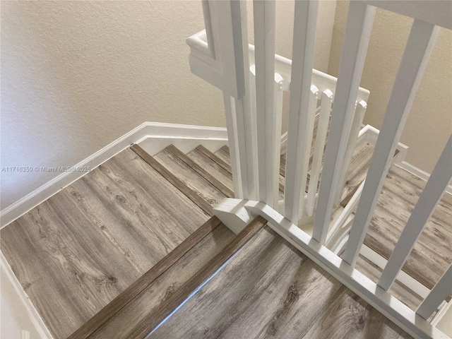 stairs with wood-type flooring