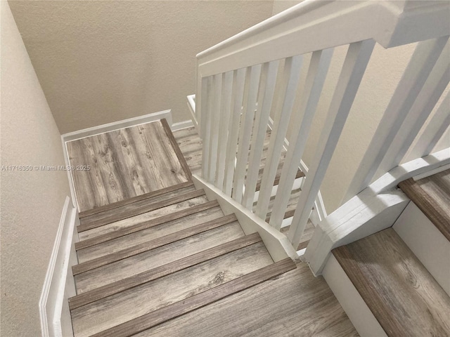 stairs featuring hardwood / wood-style flooring