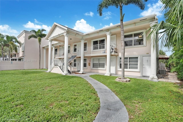 back of property featuring a lawn and central AC