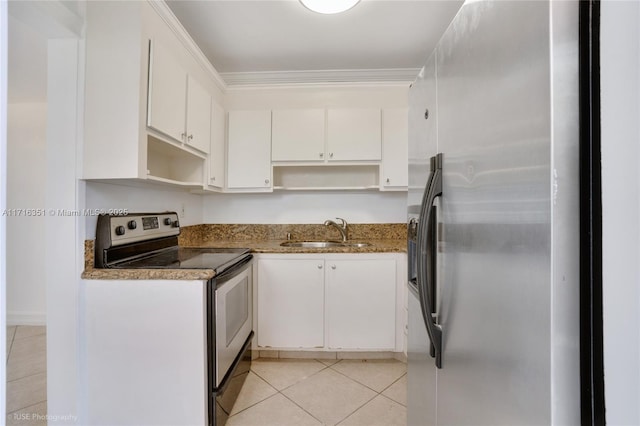 kitchen with white cabinets, sink, dark stone countertops, light tile patterned floors, and appliances with stainless steel finishes