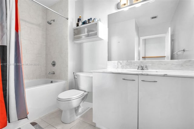 full bathroom featuring tile patterned floors, vanity, toilet, and shower / tub combo