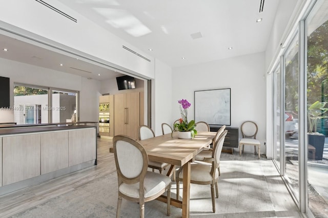 dining room featuring recessed lighting and light wood-type flooring