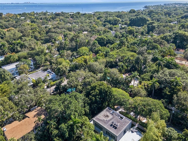 aerial view featuring a wooded view and a water view