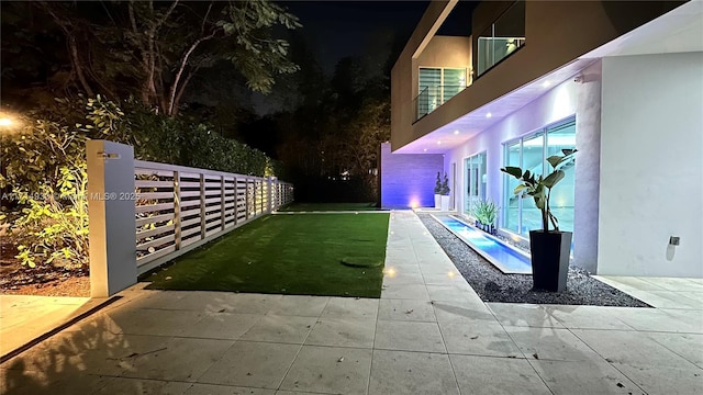 view of yard featuring a patio and fence