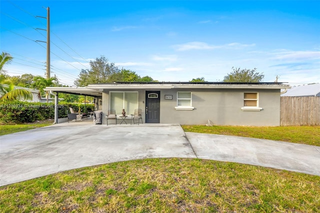 single story home with a front yard and a carport