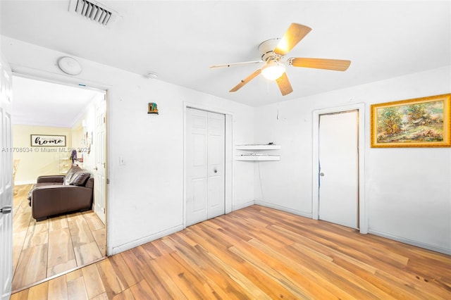 bedroom with light hardwood / wood-style floors and ceiling fan