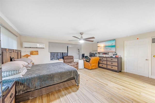 bedroom featuring light hardwood / wood-style flooring, a wall mounted AC, and ceiling fan