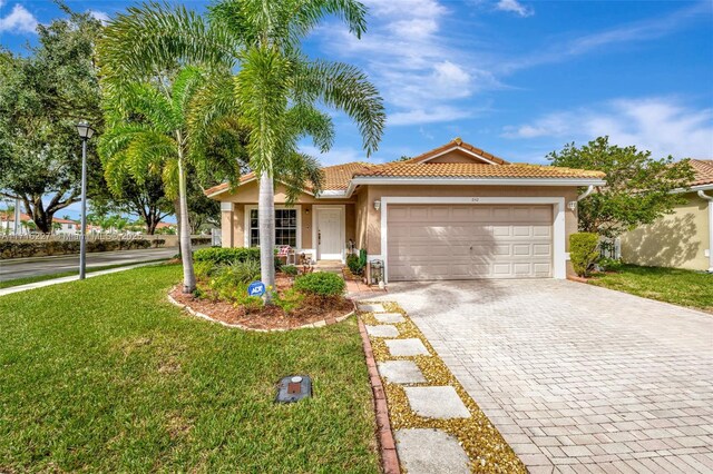 view of front of house featuring a front yard and a garage