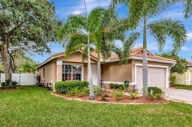 view of front facade with a front yard and a garage