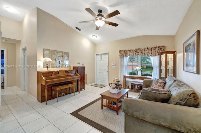 tiled living room featuring ceiling fan and lofted ceiling