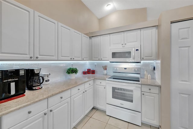 kitchen featuring white cabinetry, white appliances, tasteful backsplash, and light tile patterned floors