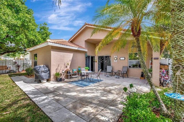 back of property with a patio