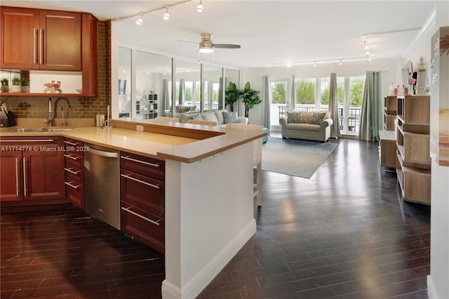 kitchen with dishwasher, ceiling fan, kitchen peninsula, and sink