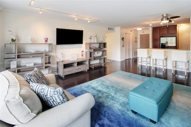 living room featuring ceiling fan, rail lighting, dark hardwood / wood-style floors, and ornamental molding